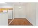 Bright dining area adjacent to the kitchen with hardwood floors and stylish chandelier, perfect for Gathering meals at 10784 W 63Rd Pl # 205, Arvada, CO 80004