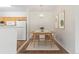Cozy dining area with modern decor, a chandelier, and hardwood floors next to the bright kitchen at 10784 W 63Rd Pl # 205, Arvada, CO 80004