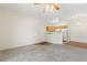 Open concept living area, with newer carpet, entrance, and adjacent kitchen at 10784 W 63Rd Pl # 205, Arvada, CO 80004