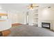 Cozy living room features a fireplace and built-in shelves, seamlessly connecting to the dining area and kitchen at 10784 W 63Rd Pl # 205, Arvada, CO 80004