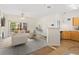 Inviting living room featuring an open layout with hardwood flooring, fireplace and a view to the modern kitchen at 10784 W 63Rd Pl # 205, Arvada, CO 80004