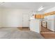 Open concept living area, with newer carpet, entrance, and adjacent kitchen at 10784 W 63Rd Pl # 205, Arvada, CO 80004