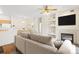 Open-concept living area with a fireplace, built-in shelves, dining space, and comfortable seating at 10784 W 63Rd Pl # 205, Arvada, CO 80004