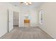 Spacious main bedroom with neutral carpet, connecting to a walk-in closet and an ensuite bathroom at 10784 W 63Rd Pl # 205, Arvada, CO 80004