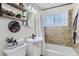 Cozy bathroom features a tiled shower/tub, toilet, and vanity with decorative accents at 841 N Oakland St, Aurora, CO 80010