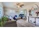 Bright living room featuring a ceiling fan, comfortable sofas, and stylish decor accents with natural light at 841 N Oakland St, Aurora, CO 80010