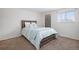 Bright bedroom with wood bed frame and carpet flooring at 3048 S Akron Ct, Denver, CO 80231