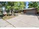 Front view of a ranch home with a large driveway and mailbox at 3048 S Akron Ct, Denver, CO 80231