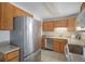 Kitchen features stainless steel appliances and ample wood cabinetry at 3048 S Akron Ct, Denver, CO 80231