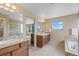 Neutral bathroom featuring double sinks, large vanity mirrors, and separate shower and soaking tub areas at 9530 Gray St, Westminster, CO 80031