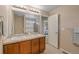 Well-lit bathroom featuring double sinks, a large mirror, and a shower/tub combo at 9530 Gray St, Westminster, CO 80031