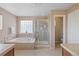 Bright bathroom featuring a glass-door shower, soaking tub, and neutral tile work at 9530 Gray St, Westminster, CO 80031