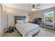 Cozy bedroom with decorative headboard, desk, and natural light from the large window at 9530 Gray St, Westminster, CO 80031