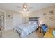 Cozy bedroom with decorative headboard, desk, and large closet at 9530 Gray St, Westminster, CO 80031