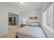 Cozy bedroom featuring a comfortable bed, a window, and a view into another room at 9530 Gray St, Westminster, CO 80031