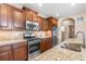 Modern kitchen with stainless steel appliances, granite countertops, stylish tile backsplash, and ample cabinet space at 9530 Gray St, Westminster, CO 80031