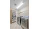 Modern laundry room equipped with stainless steel washer and dryer and shelving for storage at 9530 Gray St, Westminster, CO 80031