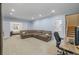 Spacious living room with a comfortable sectional, desk area, and access to other rooms at 9530 Gray St, Westminster, CO 80031