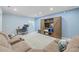 Cozy living room featuring a large sectional sofa, a media center, and desk at 9530 Gray St, Westminster, CO 80031