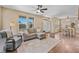 Open-concept living room featuring a comfortable couch, hardwood floors, and bright windows at 9530 Gray St, Westminster, CO 80031