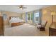 Bright main bedroom featuring neutral decor, ceiling fan, and natural light from the large windows at 9530 Gray St, Westminster, CO 80031