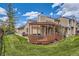 Spacious backyard featuring a wooden deck and lush green lawn, perfect for outdoor enjoyment and entertaining at 10510 W Fair Ave # A, Littleton, CO 80127