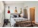 Cozy bedroom featuring a comfortable bed, decorative pillows, and unique guitar decor on the walls at 10510 W Fair Ave # A, Littleton, CO 80127