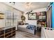 Cozy bedroom with neutral walls, plenty of natural light and marine decor at 10510 W Fair Ave # A, Littleton, CO 80127