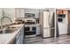 Well-equipped kitchen with stainless steel appliances and granite countertops at 10510 W Fair Ave # A, Littleton, CO 80127