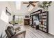 Bright living room with vaulted ceilings, skylights, a fireplace, and a sliding door to a deck at 10510 W Fair Ave # A, Littleton, CO 80127