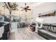 Open-concept living room with hardwood floors and vaulted ceiling leading to dining and kitchen areas at 10510 W Fair Ave # A, Littleton, CO 80127