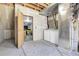 Unfinished basement with exposed utilities, washer, and dryer ready for customization and added living space at 12031 E Ford Cir, Aurora, CO 80012