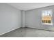 Bright, minimalist bedroom with neutral tones and a large window allowing natural light to flood the space at 12031 E Ford Cir, Aurora, CO 80012