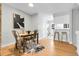 Dining area with hardwood floors and seamless flow to the kitchen and living room at 12031 E Ford Cir, Aurora, CO 80012