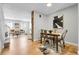Open concept dining and living room with modern decor and hardwood floors at 12031 E Ford Cir, Aurora, CO 80012