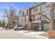 Street view of colorful townhomes with garages and mature trees at 12031 E Ford Cir, Aurora, CO 80012