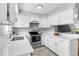 This kitchen has lots of natural light, white cabinets and stainless steel appliances at 12031 E Ford Cir, Aurora, CO 80012
