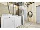 Functional laundry room equipped with a washer, dryer, and essential utility connections at 12031 E Ford Cir, Aurora, CO 80012
