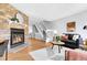 Inviting living room features a stone fireplace, hardwood floors, and a cozy seating area with natural light at 12031 E Ford Cir, Aurora, CO 80012