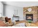 Charming living room boasting a stone fireplace, elegant decor, and comfortable seating, perfect for relaxation at 12031 E Ford Cir, Aurora, CO 80012
