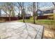 A backyard with a concrete patio, surrounded by a wooden fence and trees at 4565 Pussywillow Ct, Boulder, CO 80301
