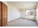Clean bedroom with neutral carpet, closet, window, and baseboard trim at 4565 Pussywillow Ct, Boulder, CO 80301