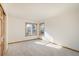Bright, empty bedroom featuring soft carpet, natural light, and baseboard trim at 4565 Pussywillow Ct, Boulder, CO 80301