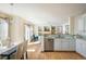 Bright kitchen with stainless steel appliances, white cabinetry and hardwood floors at 4565 Pussywillow Ct, Boulder, CO 80301