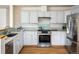 Bright kitchen featuring stainless steel appliances, white cabinets, and light backsplash at 4565 Pussywillow Ct, Boulder, CO 80301