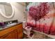 Bathroom with wood vanity and decorative shower curtain at 11052 Zephyr St, Broomfield, CO 80021