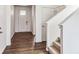 Bright entryway featuring wood floors, a glass panel front door and access to the carpeted stairs at 13465 Valentia Pl, Thornton, CO 80602