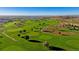 Scenic aerial view of the community golf course showcasing lush greens and fairways at 13465 Valentia Pl, Thornton, CO 80602