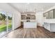 Modern open-concept kitchen features gray cabinets, a kitchen island and stainless steel appliances at 13465 Valentia Pl, Thornton, CO 80602