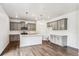Modern kitchen features gray cabinets, a kitchen island with pendant lights, and stainless steel appliances at 13465 Valentia Pl, Thornton, CO 80602